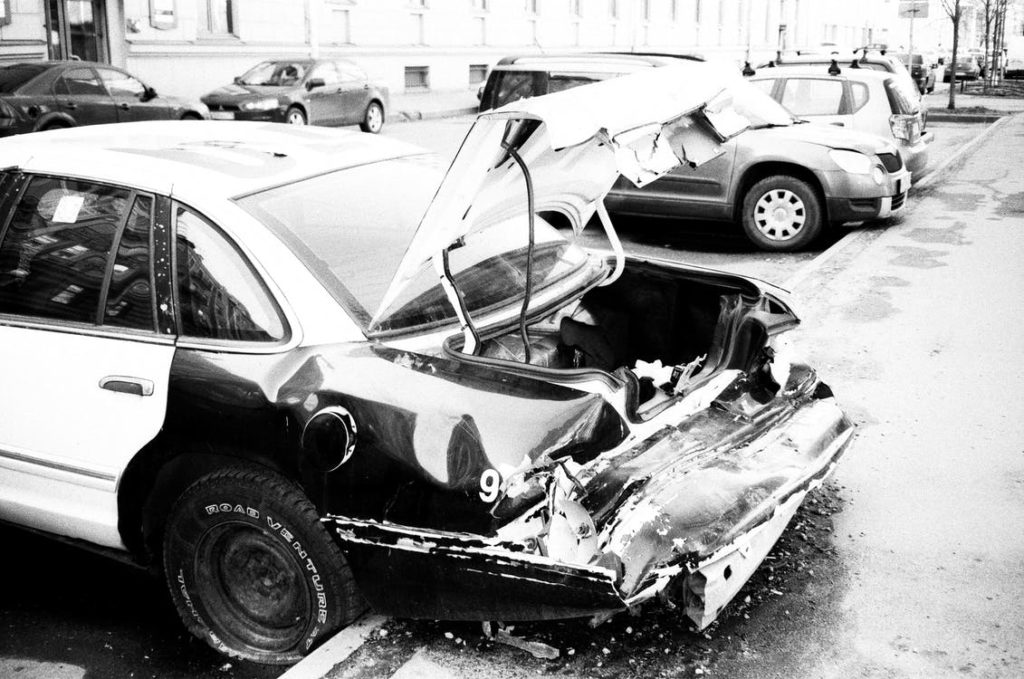 A car with a destroyed back side