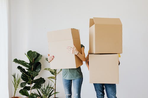 People carrying moving boxes