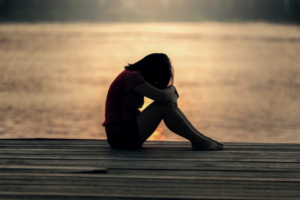 A person sitting by the sea