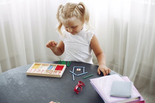 A kid sitting on a desk