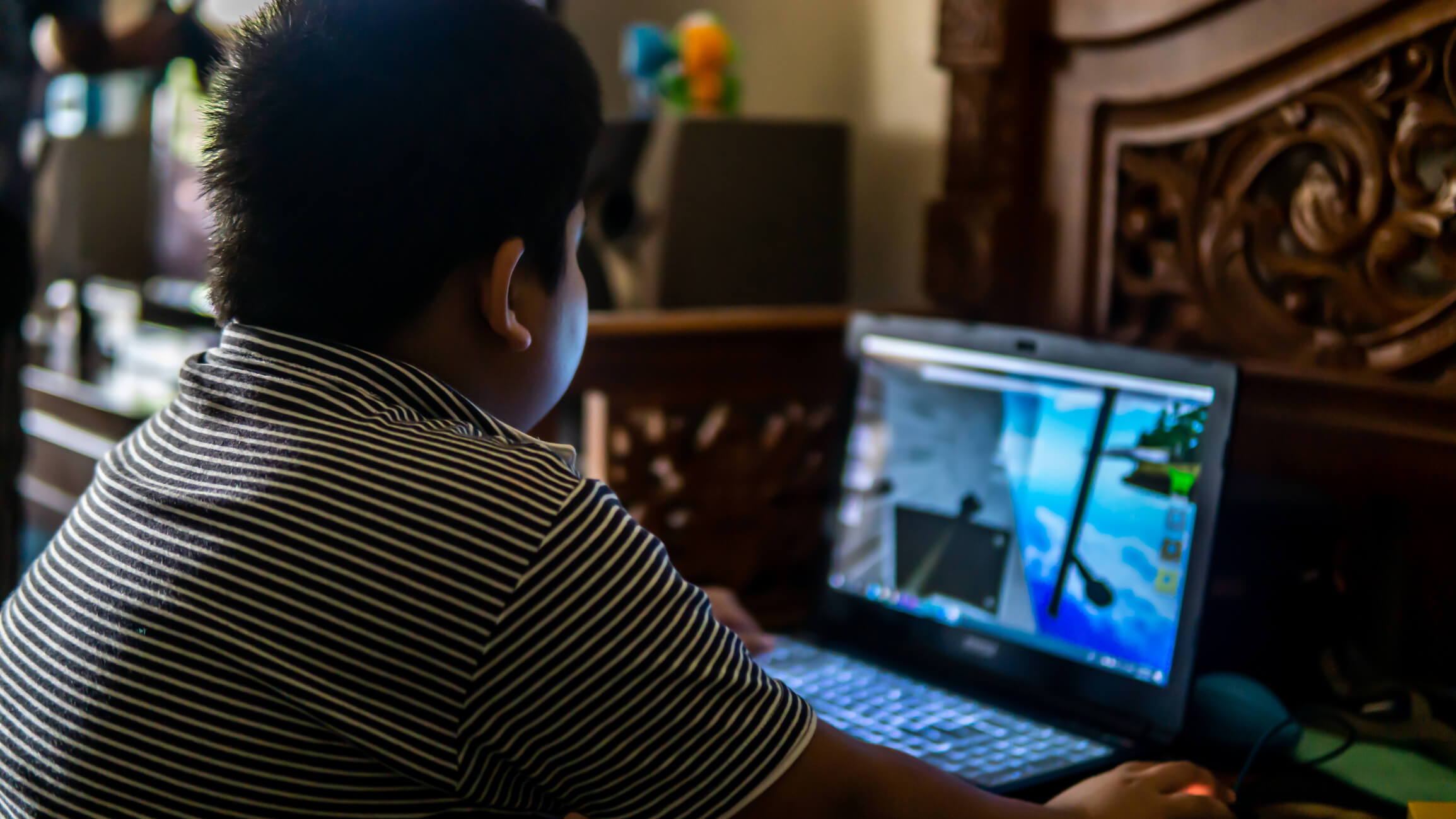 Kid playing game on a laptop