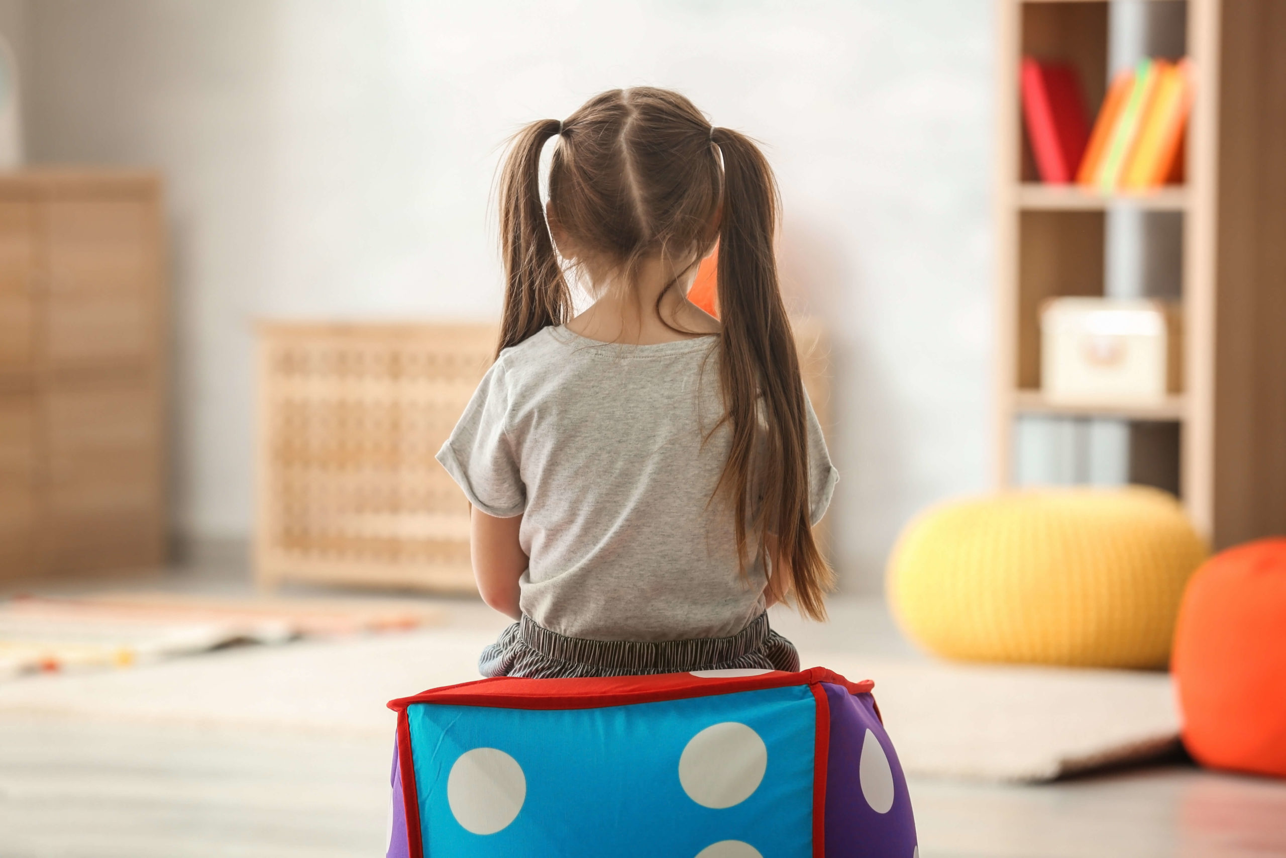 Lonely little girl sitting