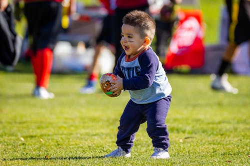A kid holding a ball