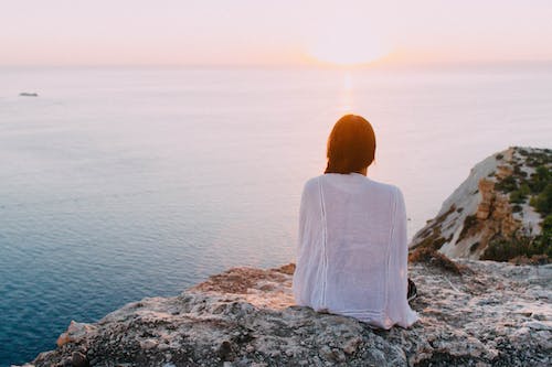 A person sitting by the sea