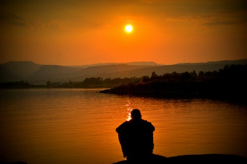 A person sitting by the sea